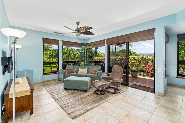 tiled living room with ceiling fan and plenty of natural light