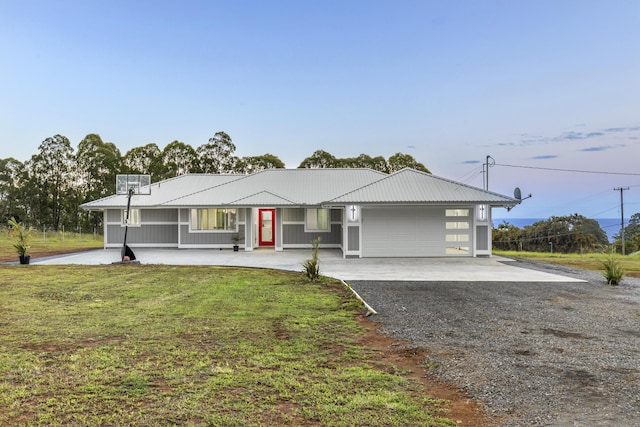 ranch-style house featuring a garage and a front yard