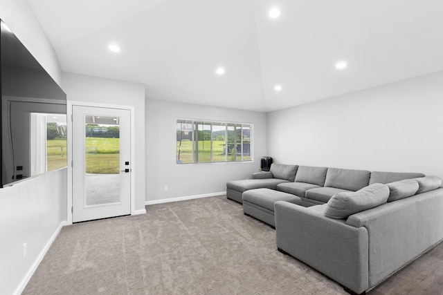 living room featuring lofted ceiling and light carpet