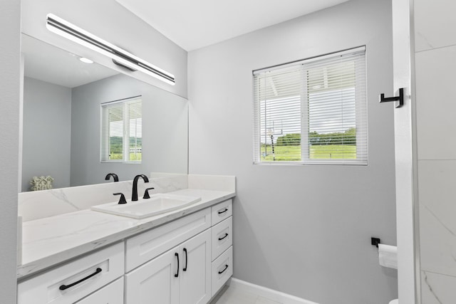 bathroom featuring a healthy amount of sunlight, tile patterned flooring, and vanity