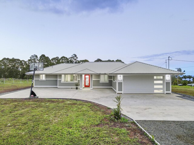 single story home featuring a garage and a front lawn