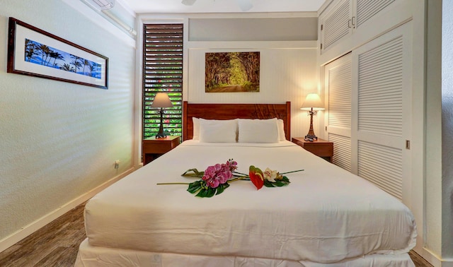 bedroom with hardwood / wood-style flooring and a closet