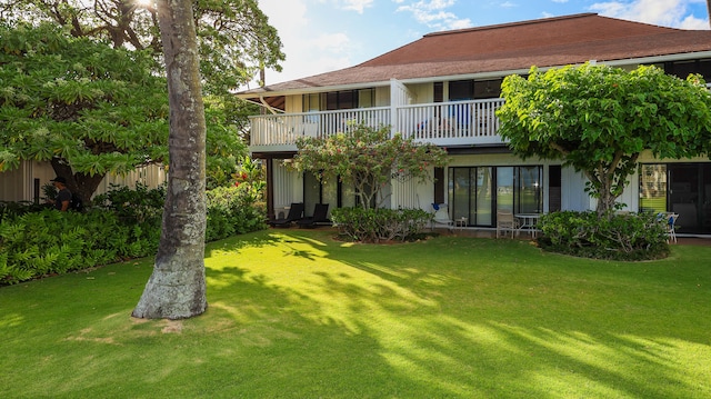 back of property featuring a lawn