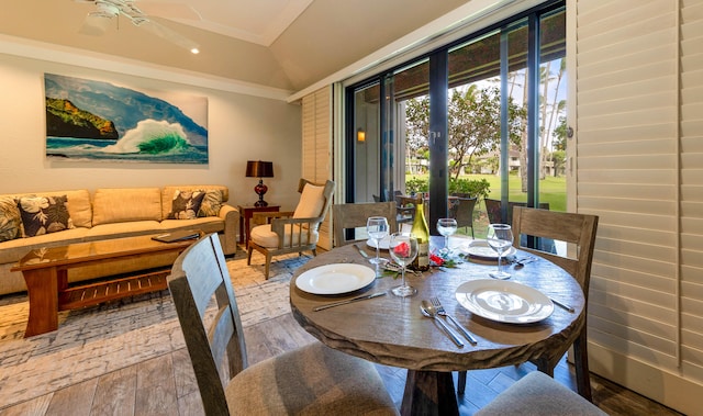 dining room with hardwood / wood-style floors, ceiling fan, lofted ceiling, and crown molding