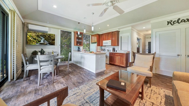 kitchen with ceiling fan, hanging light fixtures, a wall mounted air conditioner, dark hardwood / wood-style floors, and white appliances