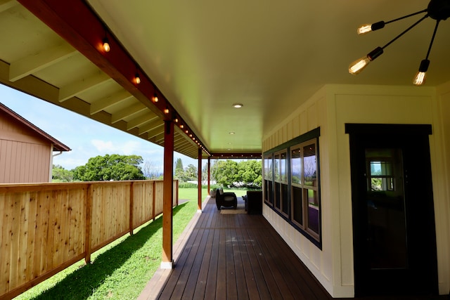 wooden terrace with a lawn