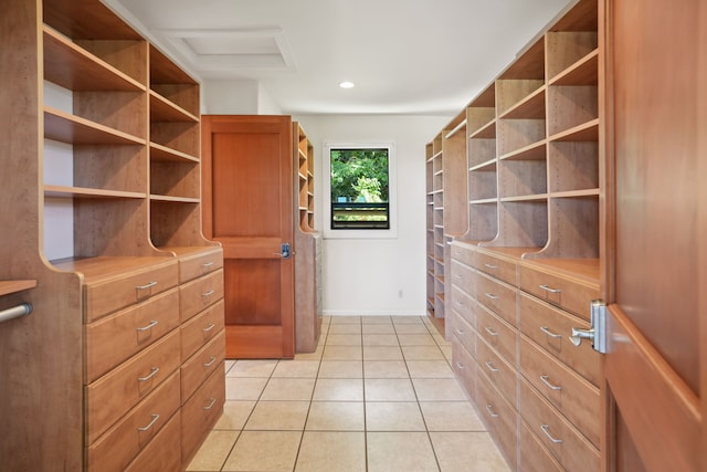 walk in closet featuring light tile patterned flooring