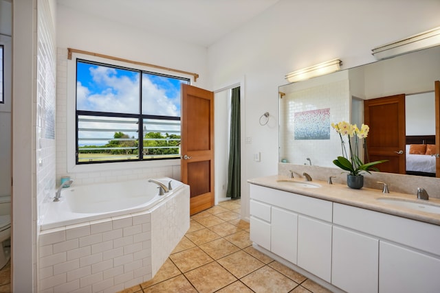 bathroom featuring tile patterned floors, a relaxing tiled tub, and dual bowl vanity