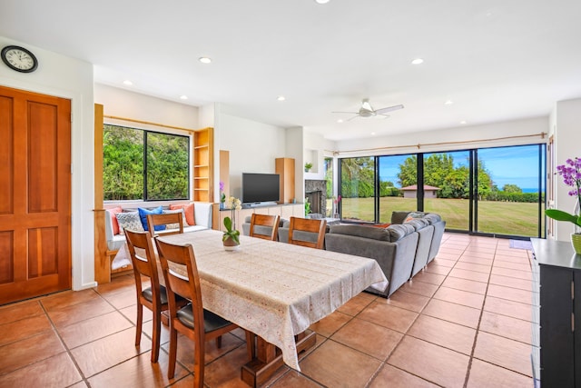 dining space featuring ceiling fan, a healthy amount of sunlight, and light tile patterned floors