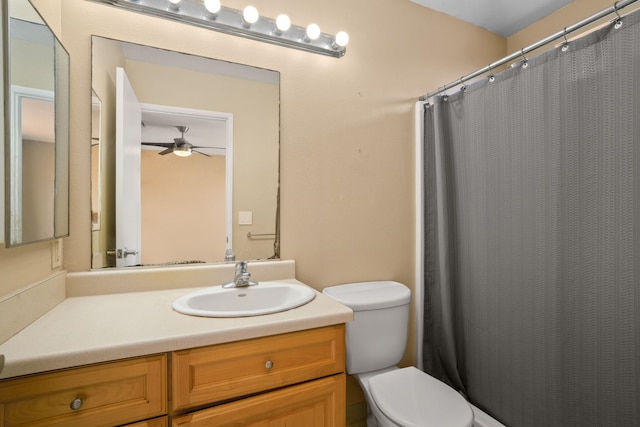 bathroom featuring vanity, toilet, and ceiling fan