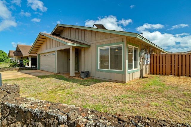 exterior space featuring a garage and a lawn