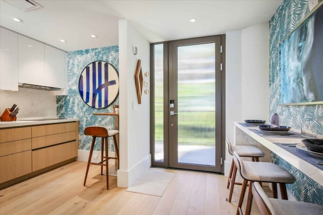 doorway with light hardwood / wood-style flooring