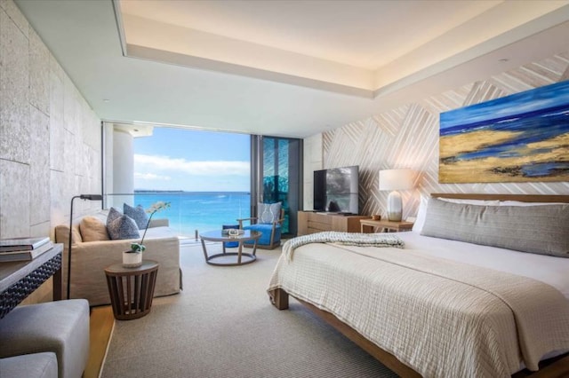 carpeted bedroom featuring a wall of windows