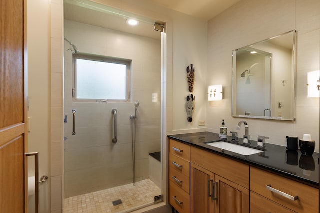 bathroom featuring walk in shower and vanity