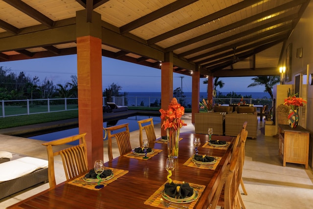 dining space featuring lofted ceiling with beams and wooden ceiling