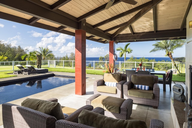 view of patio with a fenced in pool, a gazebo, outdoor lounge area, and a water view