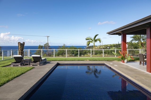 view of swimming pool with a water view, a lawn, and a patio area