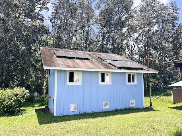 view of outbuilding featuring a yard