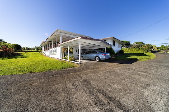 view of car parking with a carport and a lawn