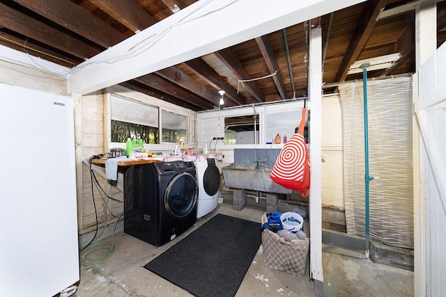 laundry room with washer and dryer and sink