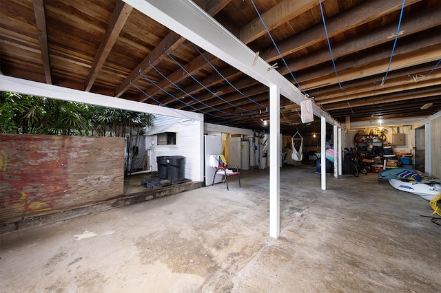 basement with electric panel and white fridge