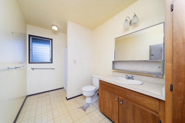 bathroom with vanity, a textured ceiling, and toilet