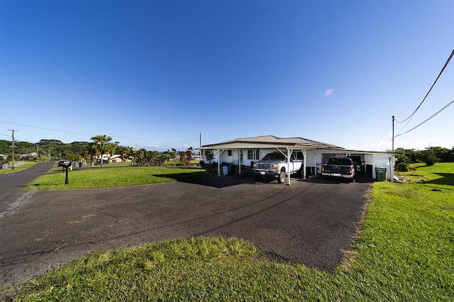 view of front of home with a front lawn and a carport