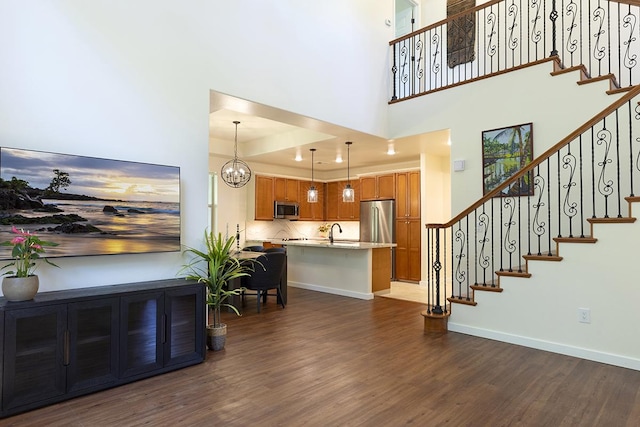 interior space with a high ceiling, a chandelier, and dark hardwood / wood-style flooring