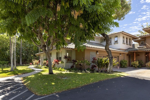 view of front of property featuring a garage and a front lawn