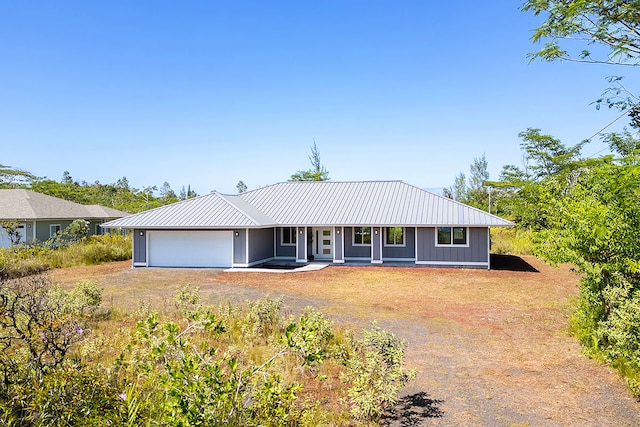 ranch-style home featuring covered porch and a garage