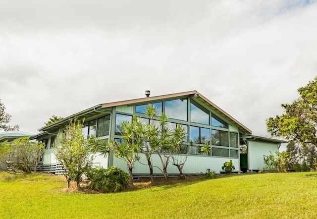 view of property exterior with a lawn