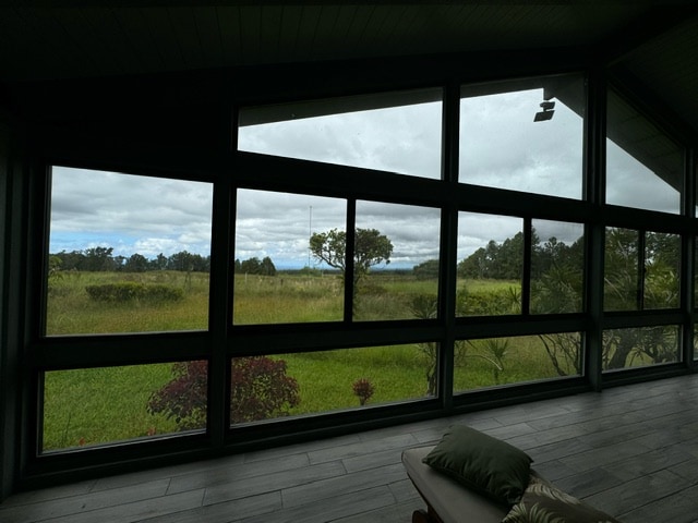 sunroom / solarium featuring lofted ceiling