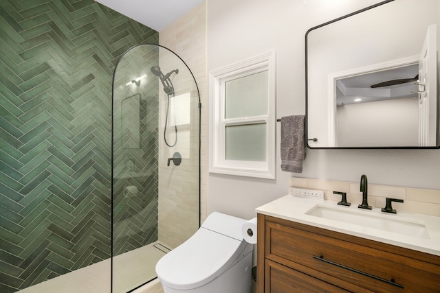 bathroom featuring ceiling fan, an enclosed shower, vanity, and toilet