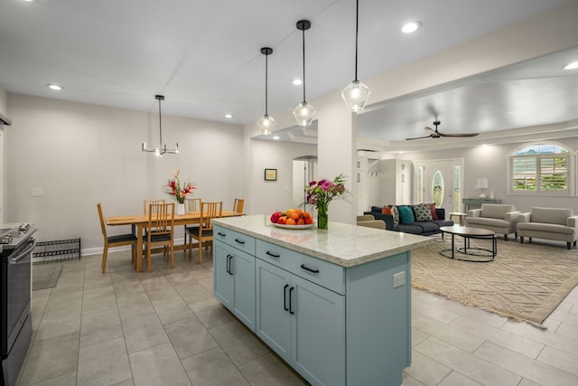 kitchen featuring light stone counters, pendant lighting, a kitchen island, ceiling fan, and light tile patterned flooring