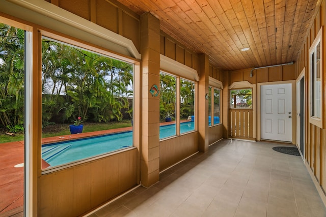 unfurnished sunroom featuring wooden ceiling