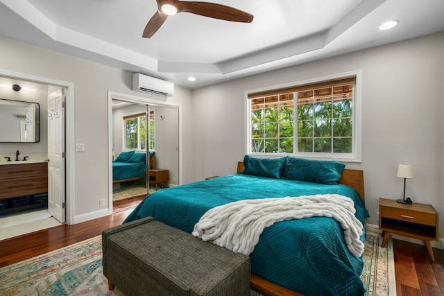 bedroom featuring ceiling fan, a raised ceiling, and hardwood / wood-style floors