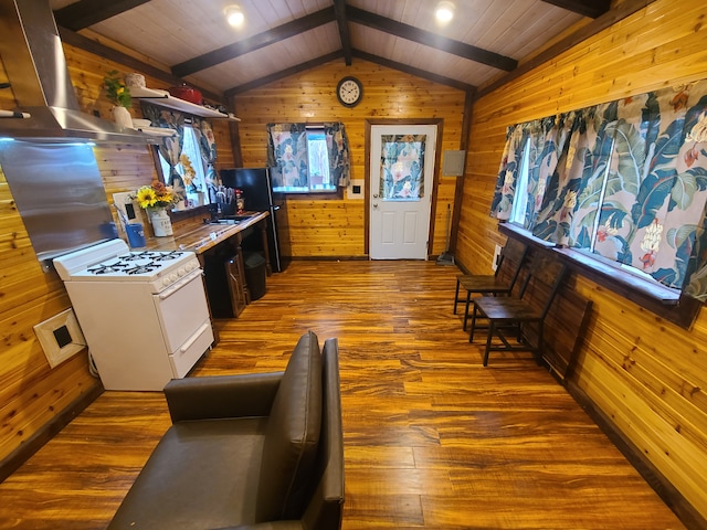 kitchen featuring hardwood / wood-style flooring, extractor fan, lofted ceiling with beams, and gas range gas stove