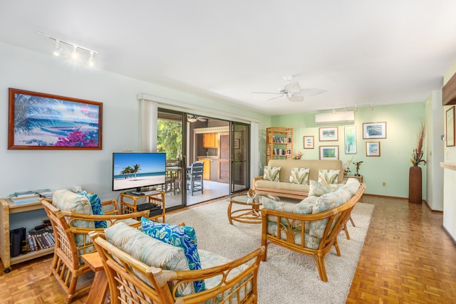 living room featuring ceiling fan, an AC wall unit, and light parquet flooring