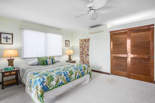 bedroom with ceiling fan, a wall unit AC, and light carpet