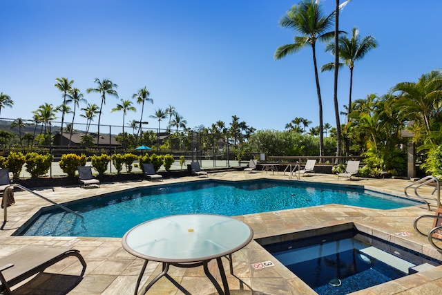 view of pool featuring a community hot tub and a patio area