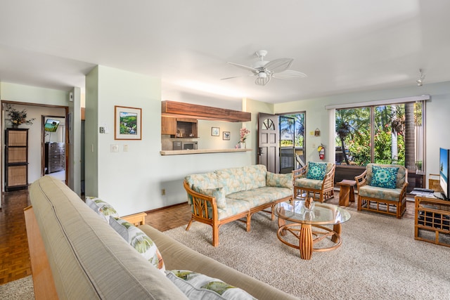 living room featuring ceiling fan and parquet flooring