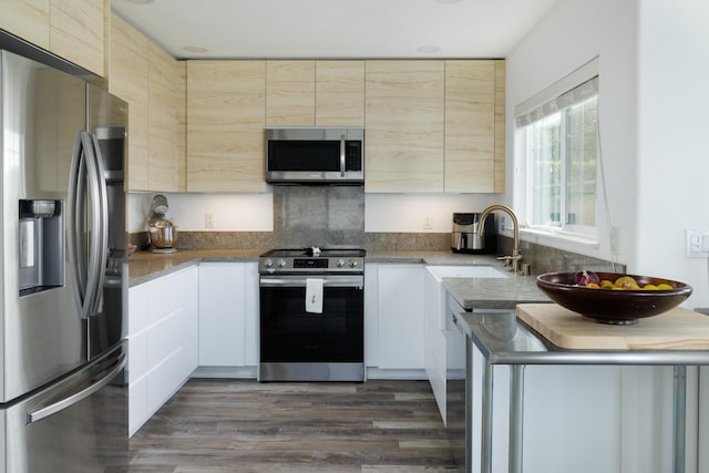 kitchen featuring white cabinetry, sink, dark hardwood / wood-style floors, and appliances with stainless steel finishes