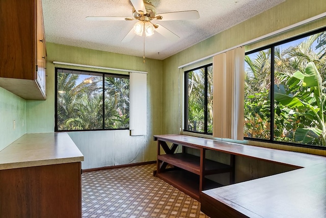 interior space featuring ceiling fan and a textured ceiling