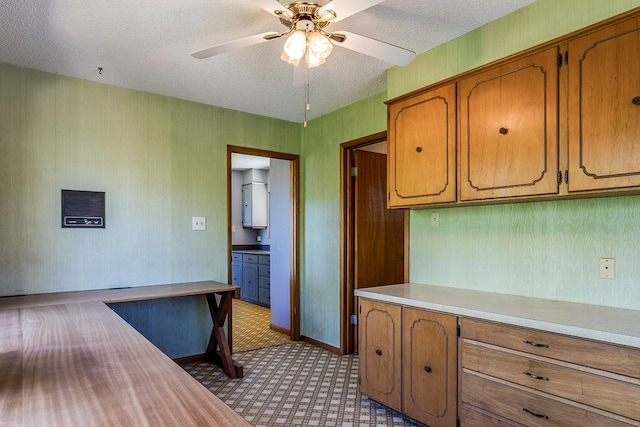 kitchen featuring ceiling fan and a textured ceiling