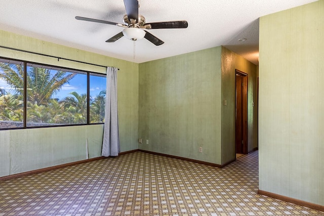 spare room featuring a textured ceiling and ceiling fan