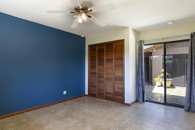 unfurnished bedroom featuring ceiling fan, access to exterior, a closet, and a textured ceiling