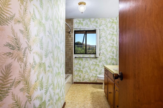 full bathroom with vanity, shower / tub combo, and toilet