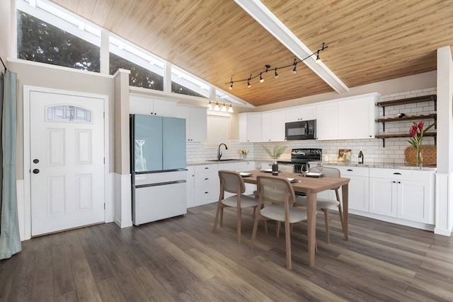 kitchen featuring white cabinets, white fridge, and dark hardwood / wood-style flooring