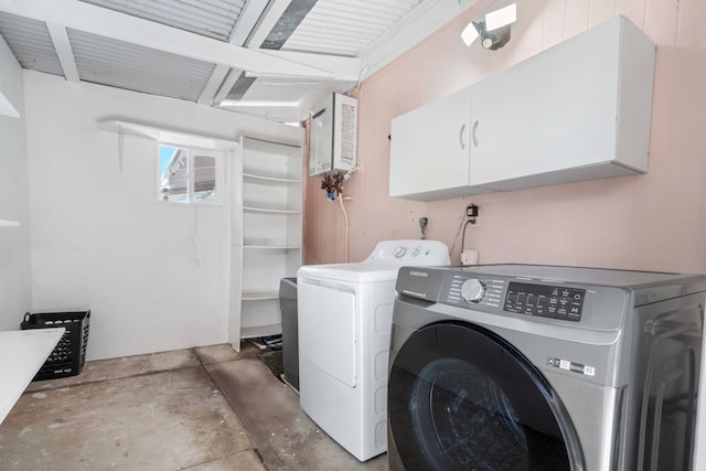 washroom featuring cabinets and washing machine and clothes dryer