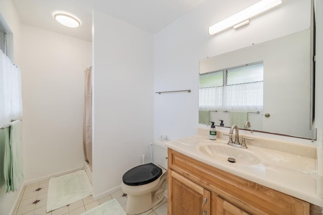 bathroom featuring toilet, tile patterned floors, vanity, baseboards, and a shower with curtain